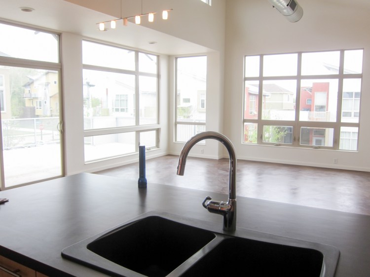 View from kitchen looking out onto living room and patio