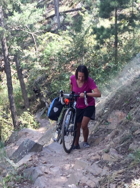 Pushing a bike up a switchback